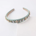 Close-up of sage green sponge headband with faux pearls and colorful crystal embellishments - Sage Green