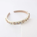 Close-up of pearl four-leaf flower headband with rhinestones on satin padding - Off White
