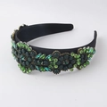 Close-up detail of Baroque headband with hand-stitched green crystals and emerald gems - Green