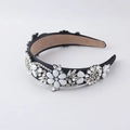 Detailed macro view of baroque headband with white floral petals and sparkling crystals - Black