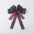Dettaglio molletta a fiocco nero con frange scintillanti di strass rossi pendenti - Rosso
