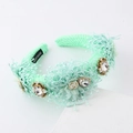 Detail of light green lace headband featuring crystals, white fabric roses and handmade label - Light Green