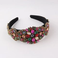 Close-up of baroque headband with colorful rhinestones and floral gem patterns - Colorful