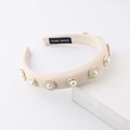 Beige sponge headband decorated with gold floral pearls and rhinestones on display - Off-white