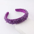 Macro detail of purple crystal bead headband with luxury velvet lining on display - Purple