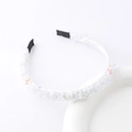 Detailed view of woven crystal flower headband with beads and pastel petals on white base - White