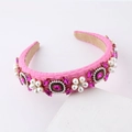 Detailed macro shot of pink baroque headband with woven fabric, pearls and pink rhinestones - Rose Red