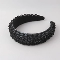 Detailed close-up of wide padded headband with intricate black bead and sequin embroidery - Black