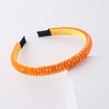Detail of yellow woven headband featuring orange faceted crystal beads and fabric tips - Orange