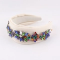 Macro detail of beige fabric headband featuring colorful rhinestones in floral patterns - Off White
