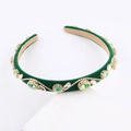 Macro view of dark green velvet headband with emerald crystals and gold settings - Dark Green