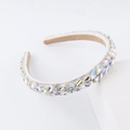 Close-up of sparkling marquee crystal rhinestones on a white sponge headband hairband - AB White (G)