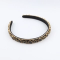 Close-up of black gemstones and rhinestones on the vintage gold baroque headband - Black