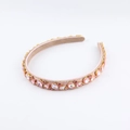 Detail of pink crystal headband showing droplet-shaped gems and soft suede inner lining - Pink