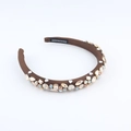Detailed macro view of multi-color crystals and HANDMADE label on baroque headband - Brown