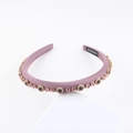Close-up of handmade satin headband with pink crystals and a black handmade label - Lotus Pink With Purple Rhinestones (F)