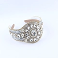 Detail of luxury padded headband with crystal rhinestones and central flower motif - Clear