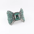 Detail of baroque headband featuring green rhinestones and emerald-cut center stone - Green