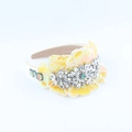 Detailed close-up of yellow sequin floral headband with crystals and pearls on white base - Yellow