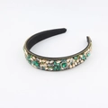 Detail of baroque headband featuring large emerald green crystals and champagne rhinestones - Emerald