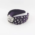 Close-up of luxury purple velvet headband featuring hand-stitched shimmering glass crystals - Purple