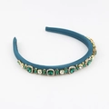 Detail of blue satin padded headband with emerald green and clear gemstones on gold alloy - Blue (E)