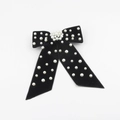 Detailed view of luxury black velvet bow hair clip with elegant white pearl embellishments - Black
