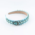 Macro detail of a baroque light blue headband with luxury rhinestones and crystal flower patterns - Aqua