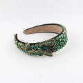 Detail of baroque velvet headband with green rhinestones and golden butterfly accents - Dark Green Butterfly Style