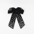 Detailed view of black velvet bow hair clip with faux pearls and sparkling rhinestones - Black