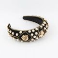Detailed close-up of velvet headband featuring golden roses and pearl embellishments - Black