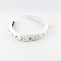 Detailed view of white satin headband with butterfly rhinestones and gold flowers - White