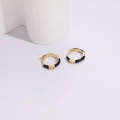 Detailed view of gold hoop earring with black enamel and a rectangular cubic zirconia - 14k / Black