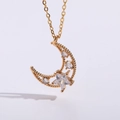 Macro detail of 14K gold plated crescent moon and star pendant with sparkling zirconias - Gold