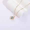 Elegante goldene Herz-Halskette mit blau-violettem Kristall und Zirkonia auf weißem Stein - Regenbogen
