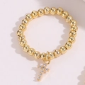 Macro detail of a 14K gold beaded ring featuring a sparkling zircon-encrusted cross charm - One Size / Style 3