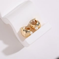 Close-up of golden C-shaped hoop earrings featuring a white pearl inlay detail - Round Ball Pearl
