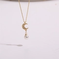 Detail of gold crescent moon pendant with sparkling zircon and white hanging pearl - Moon Pearl Style