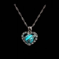 Macro detail of heart pendant with blue luminous bead and Best MOM engraving - Light Blue Glow