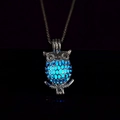 Detailed view of owl glow pendant necklace with blue luminous effect in dark lighting - Blue