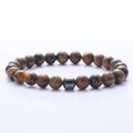 Detailed view of 8mm tiger eye stone beads on an elastic bracelet with a cylinder accent - Tiger's Eye