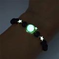 Bracciale luminoso con perline stella e luna che brilla al buio sul polso dettaglio - Oro Luce Verde