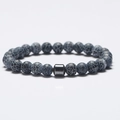 8mm natural map stone beaded bracelet with black magnetic cylinder bead on white background - Black Weathered Stone