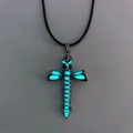 Close-up of gothic skeleton cross pendant with glowing blue luminous skull and spine - Lanyard Style / Light Blue Glow
