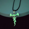 Gothic skull pendant with bat wings showing a green glowing effect in the dark - Leather Cord Green Light