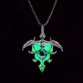 Close-up of a glowing green luminous eyeball pendant with silver punk design - Green