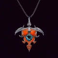 Close-up of punk eagle wing pendant with realistic blue eye and orange enamel details - Orange Light