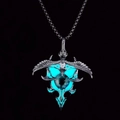 Macro detail of punk eagle pendant with glowing turquoise eye and silver wings - Cyan Glow