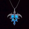 Luminous punk necklace with dragon eye and eagle wing pendant on dark background - Blue