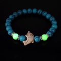 Luminous turquoise beaded bracelet with dolphin charm and blue textured round stones - Blue Turquoise Green Light